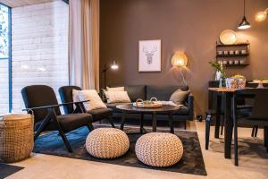 a living room with a couch and a table and chairs at Villa Havu A in Syöte
