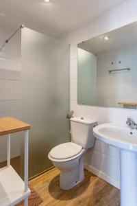 a bathroom with a toilet and a sink at Apartamentos Sendero del Veleta in Cenes de la Vega