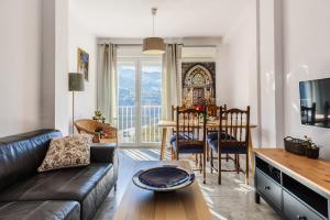 a living room with a couch and a table at Apartamentos Sendero del Veleta in Cenes de la Vega +7 photos