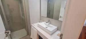 a white bathroom with a sink and a shower at Casa Linda Baía in Porto da Cruz +41 photos
