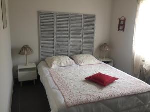 a bedroom with a bed with a red pillow on it at Villa Heliomar in Cavalaire-sur-Mer +53 photos