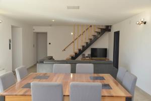 a dining room with a table and chairs and a couch at Maison avec vue et sa piscine chauffée privative in Bessas