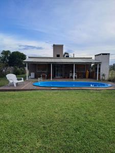 a house with a swimming pool in front of it at posada acevedo in Acevedo