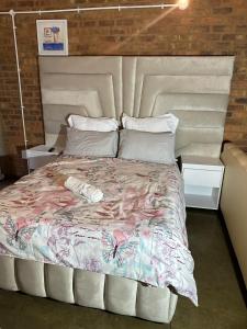 a large bed in a room with two night stands at The Hills by maboneng in Johannesburg