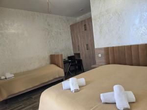 a room with two beds with towels on them at Green Cape Tower in Batumi