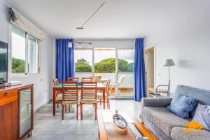 a living room with a table and a dining room at Retama Golf by Cadiz Time in Novo Sancti Petri