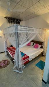 a bed with a canopy in a room at Dream Nest Ahangama in Ahangama