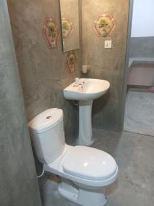a bathroom with a white toilet and a sink at Dream Nest Ahangama in Ahangama +1 photo