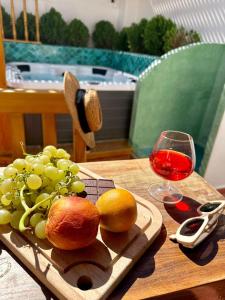 a plate of grapes and a glass of wine on a table at Riad Madinina in Marrakech +41 photos
