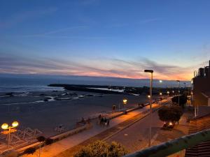 a view of a beach at night with the ocean at Casa da Praia in Vila Praia de Âncora