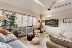 a living room with a couch and a table at Tower Hideaway Flat in city centre area of Canterbury in Canterbury