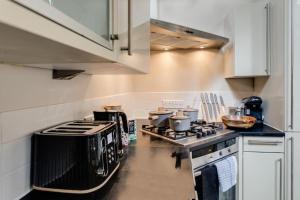 a kitchen with a stove and a counter top at Tower Hideaway Flat in city centre area of Canterbury in Canterbury