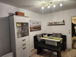 a room with a table and a chair and a cabinet at Ferienwohnung Phin in Sankt Englmar, mit Pool, activCard und Smart TV in Sankt Englmar