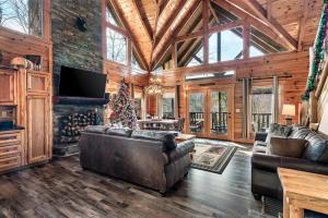 a living room with leather furniture and a fireplace at 8 Beds, Hot Tub, Fireplaces, Pool Tbl Arcade VIEWS! in Sevierville