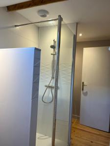 a glass shower in a room with a door at Au coeur de Perles in Perles-et-Castelet +17 photos