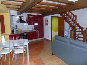 a kitchen and dining room with a table and chairs at Loft Dúplex O Viñal in Muros