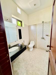 a bathroom with a sink and a toilet and a tub at Hotel Pak Continental Multan in Multan
