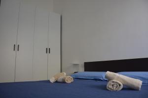 a bedroom with two towels on a bed at casa vacanze ilcieloprivato in Calasetta +31 photos