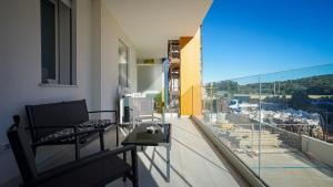 an apartment balcony with a view of a city at Brisa Blanca in Alghero
