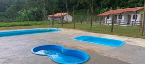 two blue trays on the ground in a playground at Fazenda Piloes in Itaipava