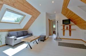a living room with a couch and a table at Appartement avec vue panoramique in Arrens-Marsous
