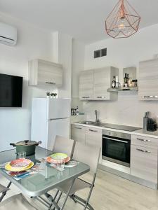 a kitchen with a glass table with two plates on it at Casa Quarta in Camogli