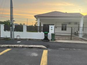 a house with a fence and a parking lot at Naura Nufail Homestay Taman Aman Anak Bukit in Alor Setar +7 photos