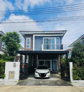 a white car parked in front of a house at Sirihouse at Supalai Bella Thalang Phuket in Phuket
