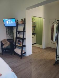 a living room with a television and a room with a bed at Harbour Delight & Harbour Comfort in Cape Town