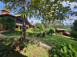 a house with a tree in front of it at La Qhia Eco Retreat in Santa Fé