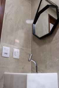 a bathroom with a sink and a mirror on the wall at Coral - Praia da Pipa in Pipa