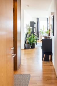 a living room with a door and potted plants at Private room with views to the mountains in Reykjavík
