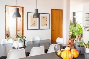 a dining room with a black table and white chairs at Private room with views to the mountains in Reykjavík