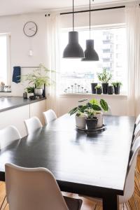 a dining room with a black table and chairs at Private room with views to the mountains in Reykjavík