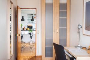a home office with a door leading into a dining room at Private room with views to the mountains in Reykjavík +37 photos
