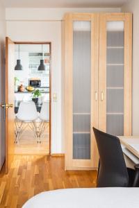 a dining room with glass doors and a table and chairs at Private room with views to the mountains in Reykjavík