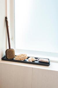 a window sill with dishes on a shelf in a kitchen at Private room with views to the mountains in Reykjavík