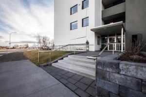 a white building with stairs in front of it at Private room with views to the mountains in Reykjavík