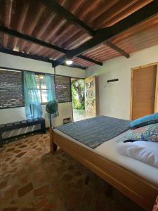 a bedroom with a large bed in a room at La Qhia Eco Retreat in Santa Fé