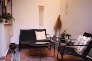 a living room with a couch and a table and chairs at The lodge by Naya in Kavála