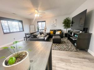 a living room with a couch and a table at Modern Condo Central Huron Boat Basin Area in Huron