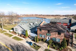an aerial view of a house with a river in the background at Modern Condo Central Huron Boat Basin Area in Huron