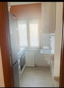 a small bathroom with a sink and a window at Casa Franco in Brugherio +16 photos