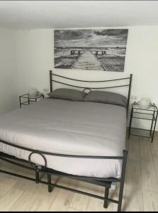 a bed in a bedroom with a picture on the wall at Casa Franco in Brugherio