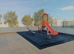 a playground on the roof of a building at Casa dos Avós - Quinas II in Armação de Pêra