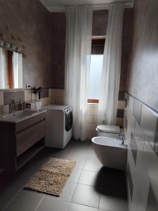 a bathroom with a sink and a toilet and a window at Casa Vacanza Magnolia in Tollo +16 photos