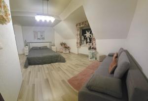 a living room with a bed and a couch at Ubytovanie Oslany in Oslany