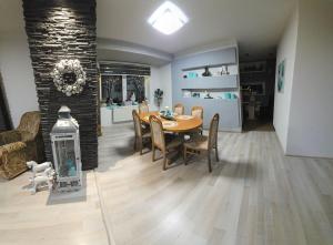 a dining room with a table and chairs and a fireplace at Ubytovanie Oslany in Oslany