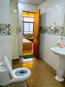 a bathroom with a toilet and a sink at Azure Atrium Abode one bedroom family apartment in Rawalpindi
