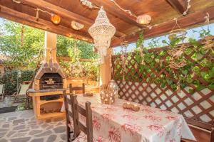 a patio with a table and a pizza oven at La Casa delle Conchiglie in Capo Coda Cavallo